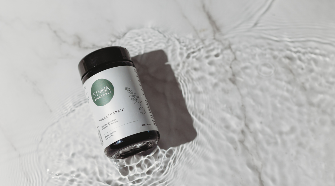 Supplement bottle with a label on a textured surface