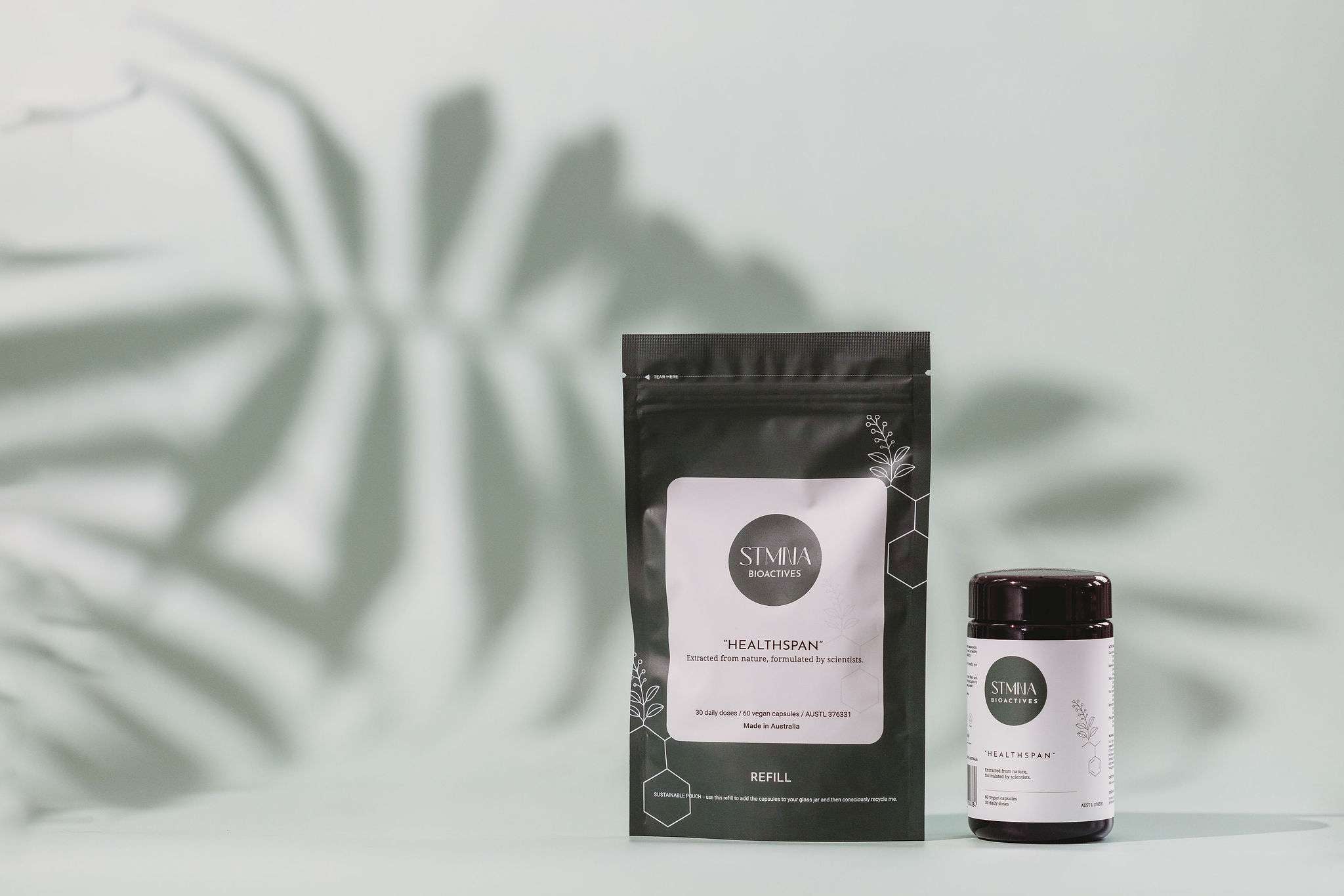 STMNA Bioactives Healthspan refill pouch and jar with plant leaf shadow